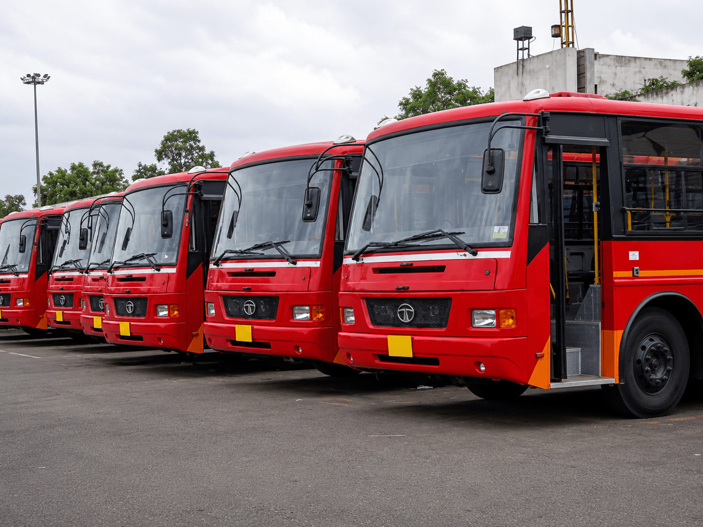 A fleet of city buses lined up at the depot